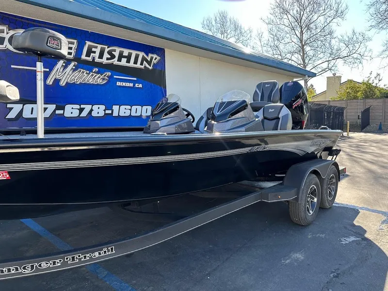 Slide: The Image of 2025 Ranger ALPHA 208 boat on trailer outside a marine shop. - 7