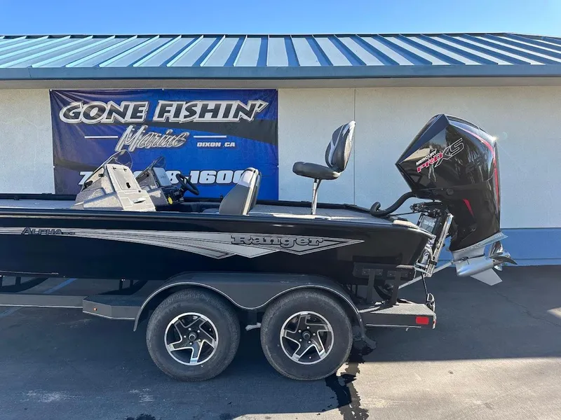 Slide: The Image of 2025 Ranger ALPHA 208 boat with motor, parked on a trailer outside a building. - 8