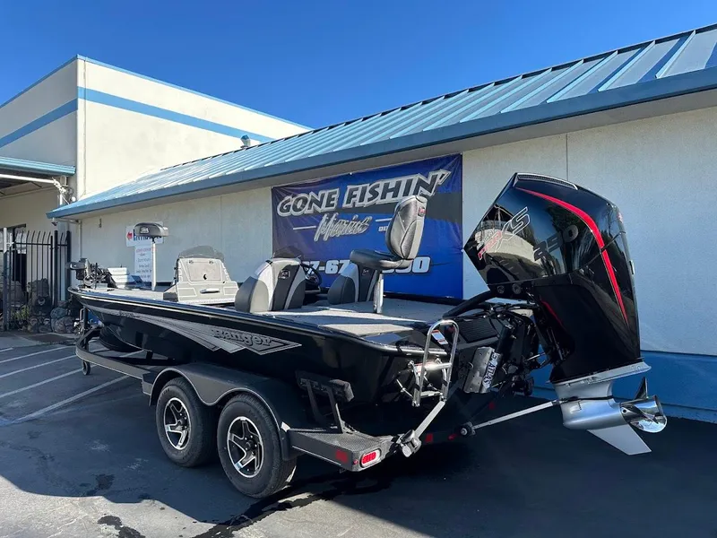 Slide: The Image of 2025 Ranger ALPHA 208 boat with powerful outboard motor, parked outside a fishing store. - 9