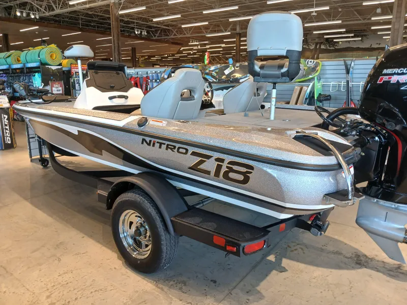 Slide: The Image of 2025 Nitro Z18 boat displayed indoors, featuring sleek design and modern seating. - 1