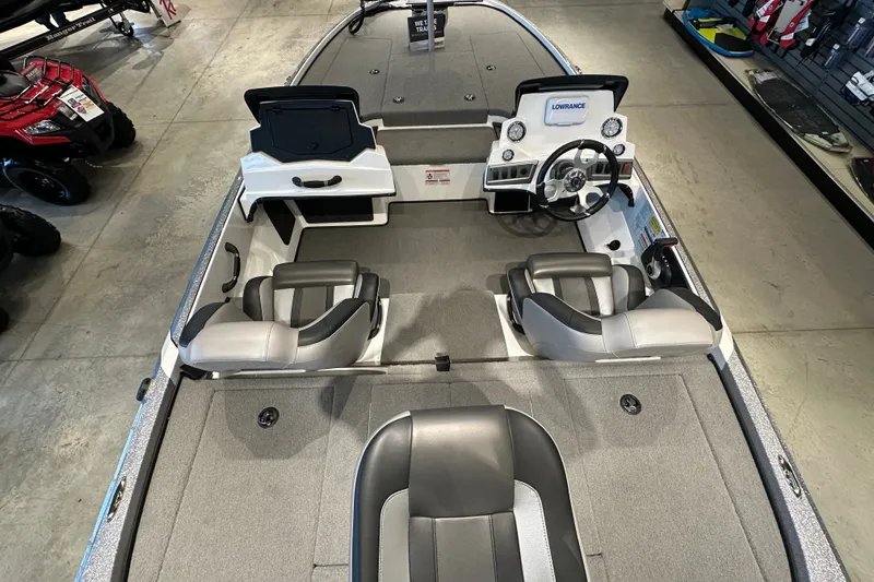 Slide: The Image of 2025 Nitro Z18 boat interior with dual seats and steering console in showroom. - 10