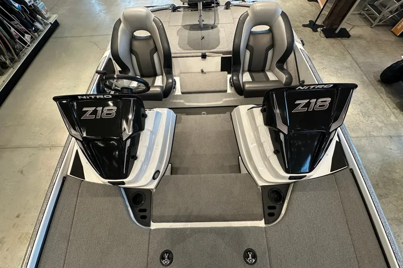 Slide: The Image of 2025 Nitro Z18 boat interior with dual seats and steering console. - 11
