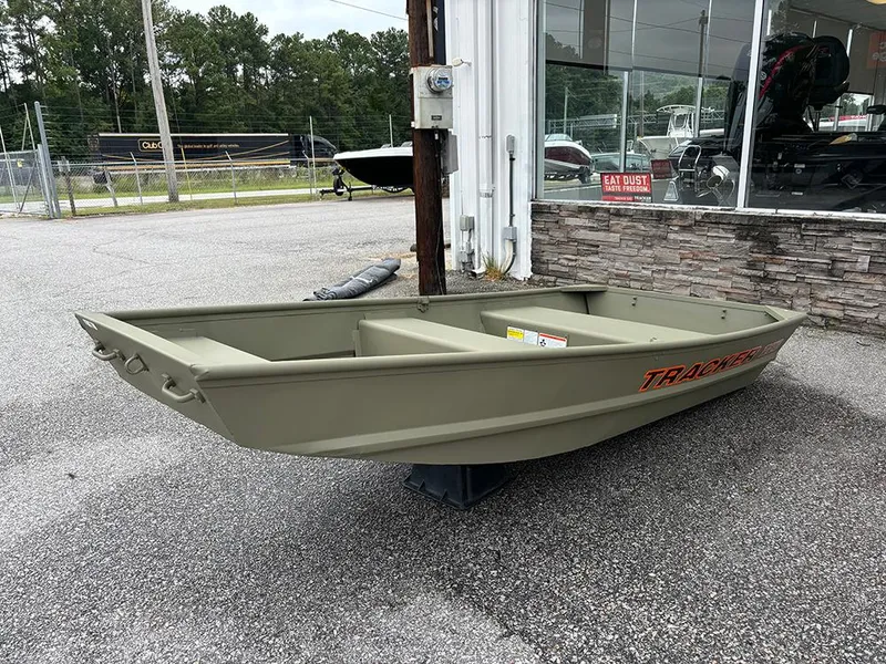 The Image of 2025 Tracker Grizzly 10 Jon boat displayed outdoors near a showroom. - 0