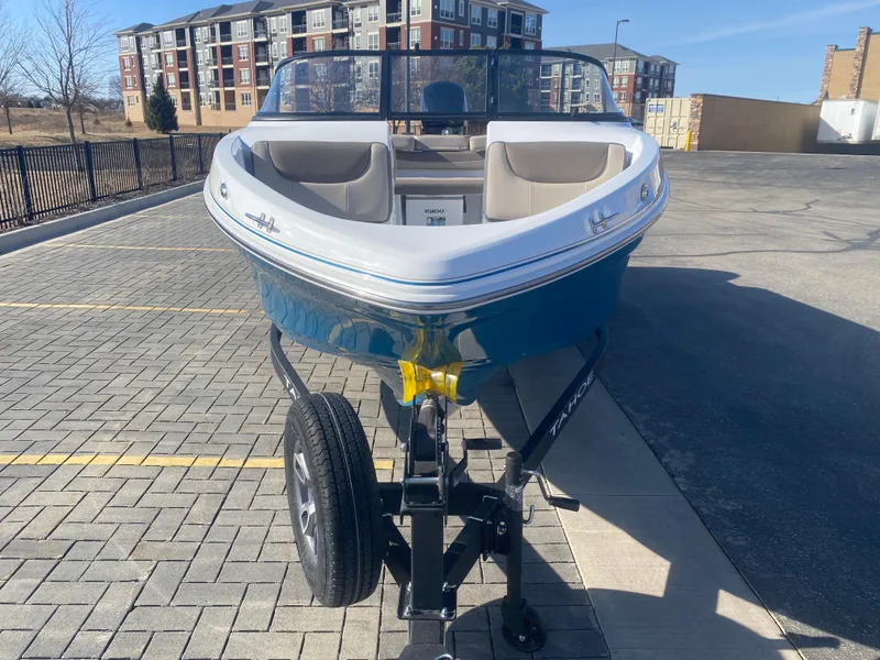 Slide: The Image of 2025 Tahoe 200 S boat on trailer in urban setting. - 2