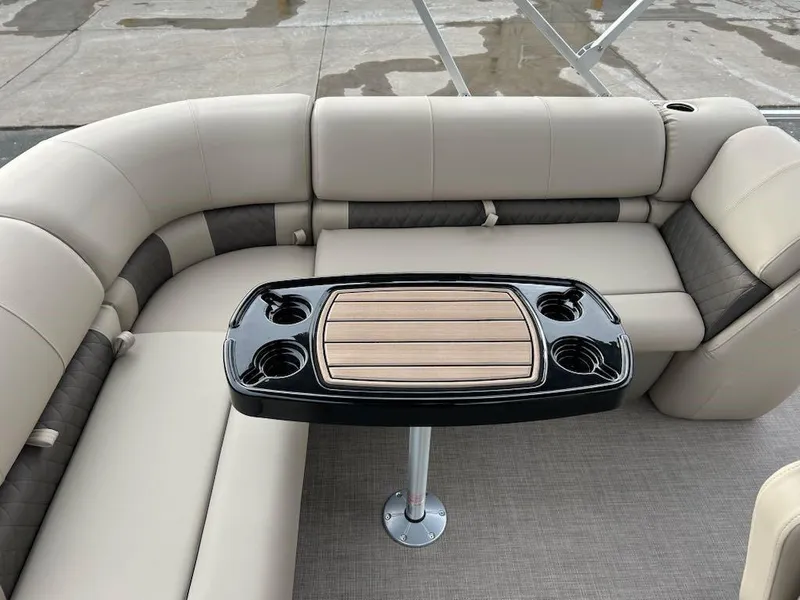 Slide: The Image of 2025 Sun Tracker Party Barge 20 DLX interior with cushioned seating and a central table. - 4