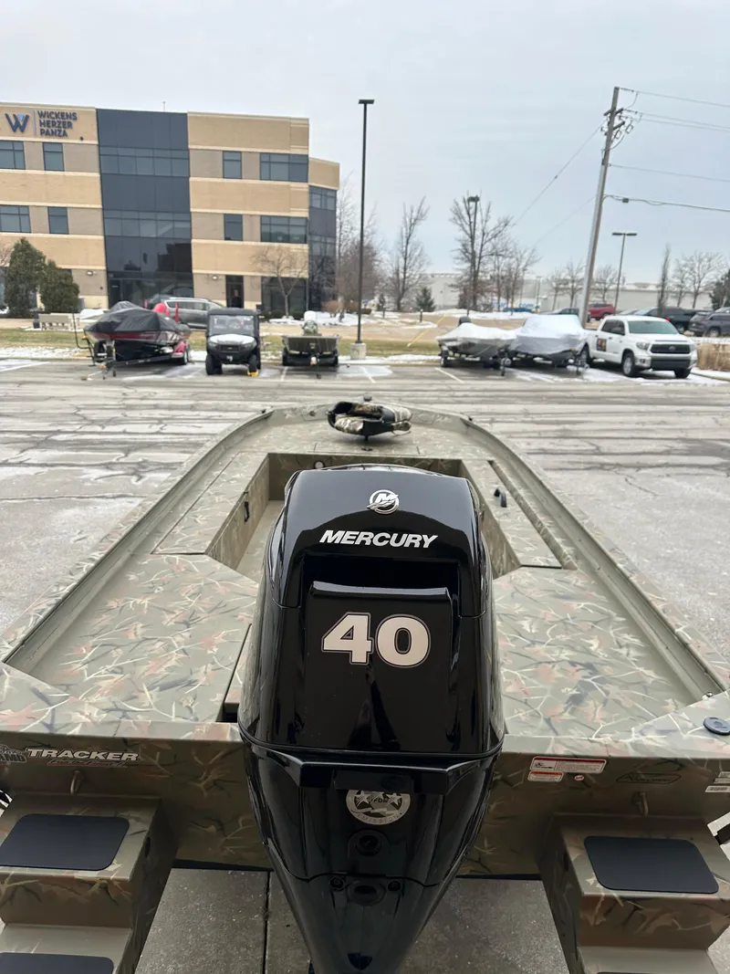 Slide: The Image of 2025 Tracker Grizzly 1654 T Sportsman boat with Mercury 40 engine in parking lot. - 5