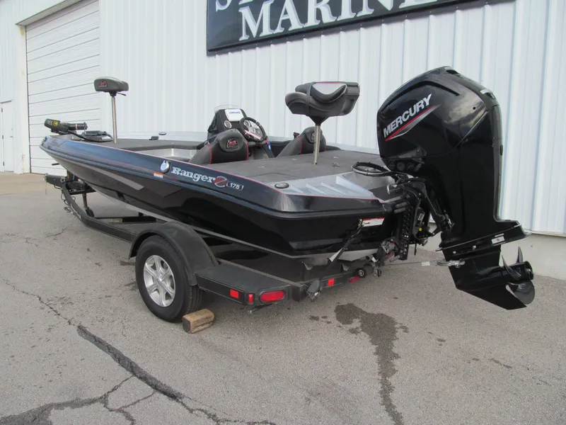 Slide: The Image of 2016 Ranger Z175 boat with Mercury engine on trailer, parked outside a marine shop. - 2
