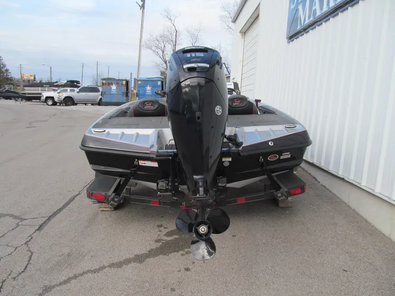Slide: The Image of 2016 Ranger Z175 boat with outboard motor, parked on a trailer near a building. - 3