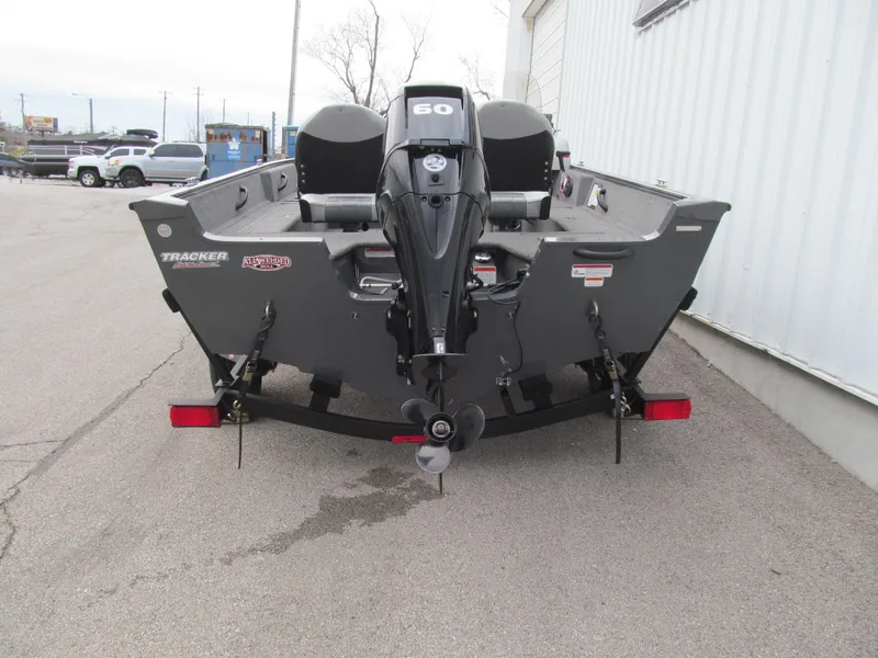 Slide: The Image of 2018 Tracker Pro Guide V-16 SC boat, rear view with outboard motor, parked on pavement. - 4