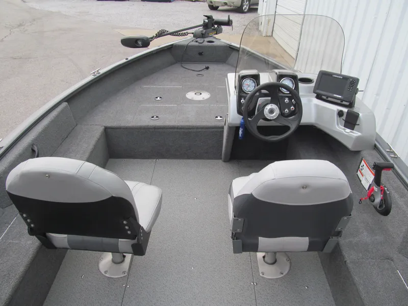 Slide: The Image of 2018 Tracker Pro Guide V-16 SC boat interior with steering console and seating. - 5