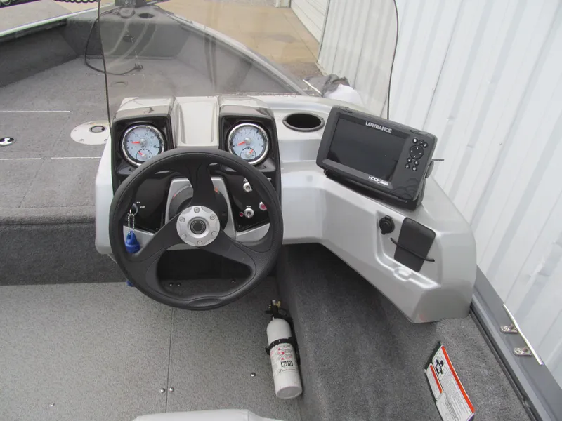 Slide: The Image of 2018 Tracker Pro Guide V-16 SC boat dashboard with steering wheel and navigation system. - 6