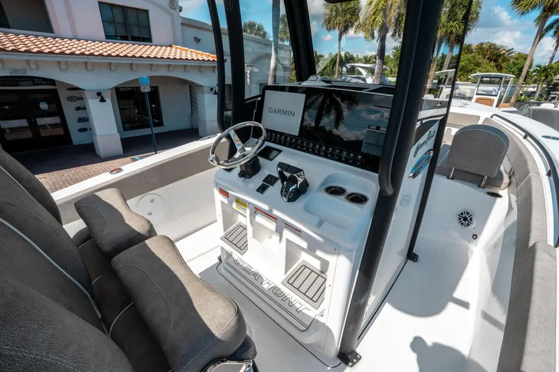 Slide: The Image of 2025 Sea Hunt Gamefish 25 boat interior with Garmin navigation system and seating. - 24