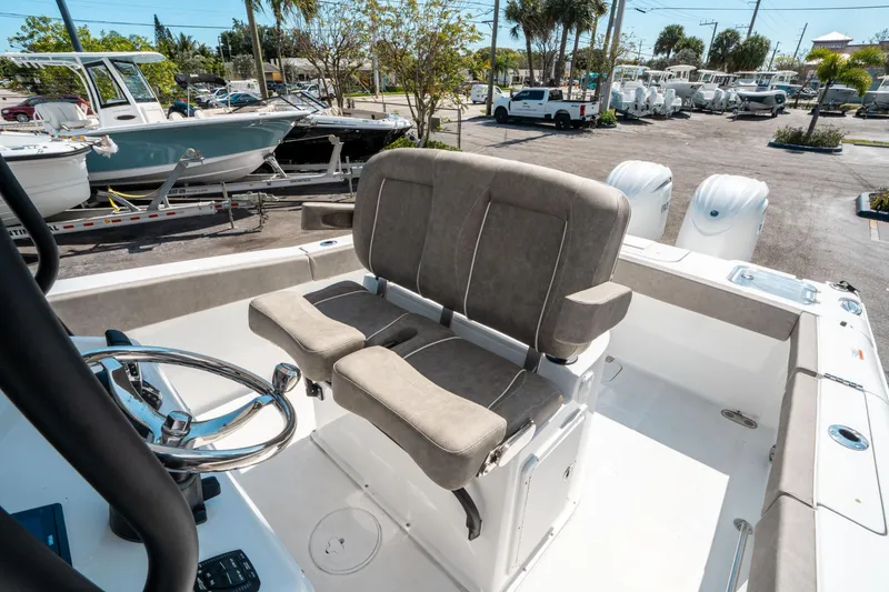 Slide: The Image of 2025 Sea Hunt Gamefish 25 boat interior with dual seats and steering wheel. - 28