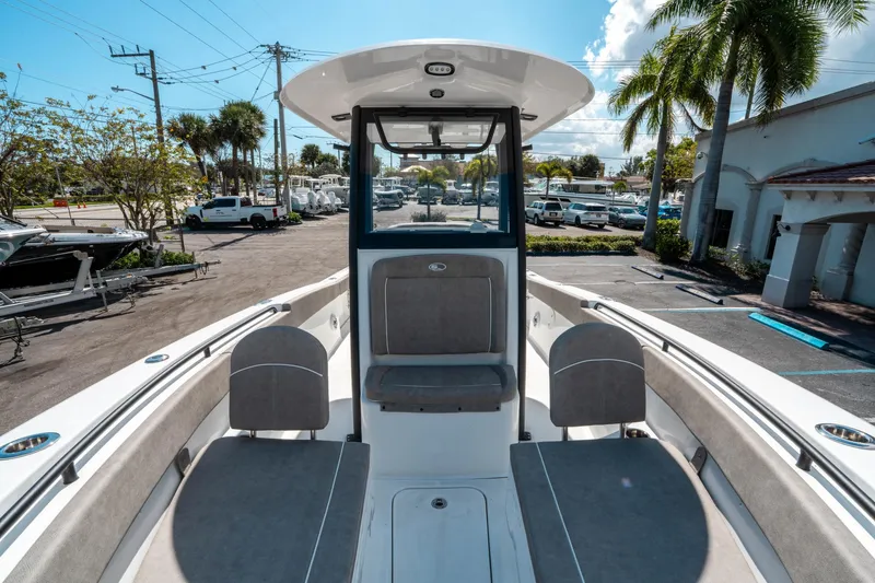 Slide: The Image of 2025 Sea Hunt Gamefish 25 boat interior with seating, parked in a marina. - 33