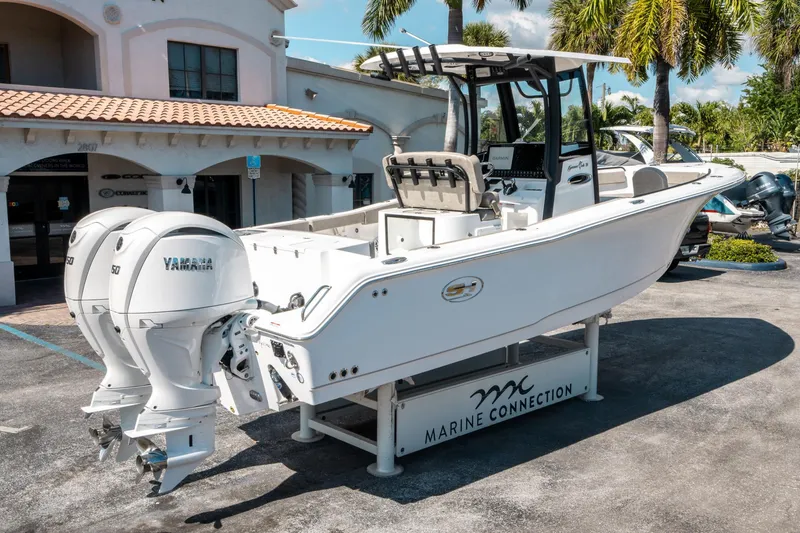 Slide: The Image of 2025 Sea Hunt Gamefish 25 boat with twin Yamaha engines displayed outdoors. - 2