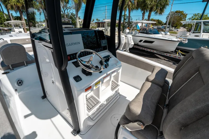 Slide: The Image of 2025 Sea Hunt Gamefish 25 boat interior with Garmin navigation system and comfortable seating. - 23