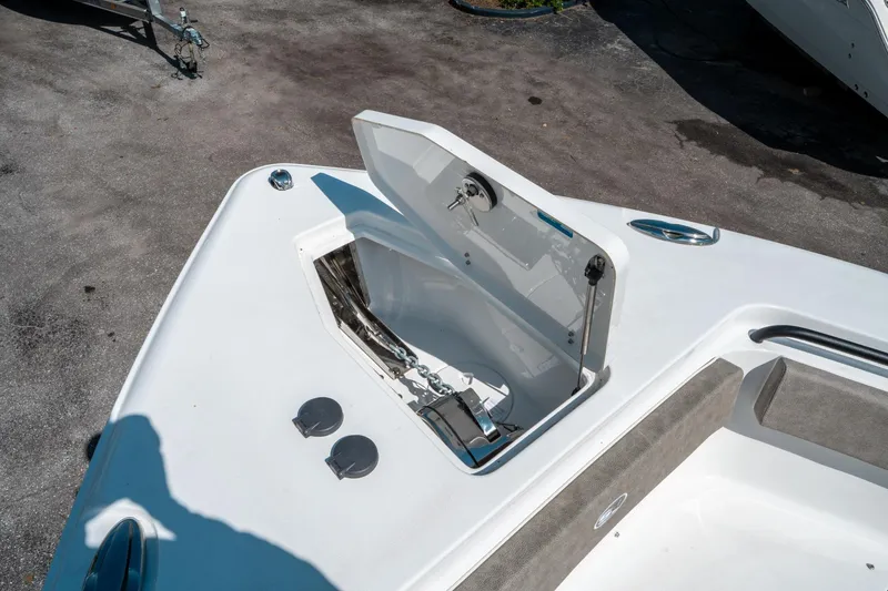 Slide: The Image of 2025 Sea Hunt Gamefish 25 boat anchor compartment open, showcasing storage space. - 39