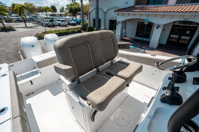 Slide: The Image of 2025 Sea Hunt Gamefish 25 boat interior with dual seats and steering wheel. - 27