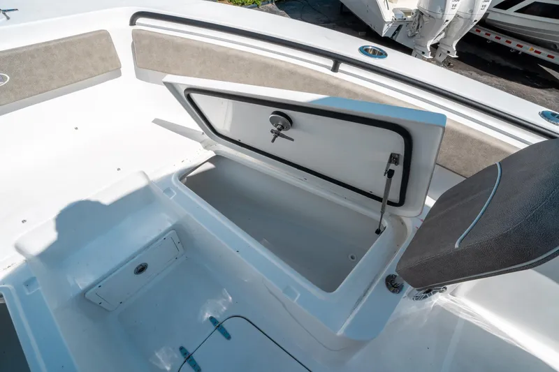 Slide: The Image of 2025 Sea Hunt Gamefish 25 boat storage compartment with open hatch and cushioned seating. - 37