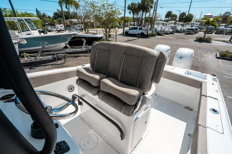 Slide: The Image of 2025 Sea Hunt Gamefish 25 boat interior with dual seats and steering wheel. - 25