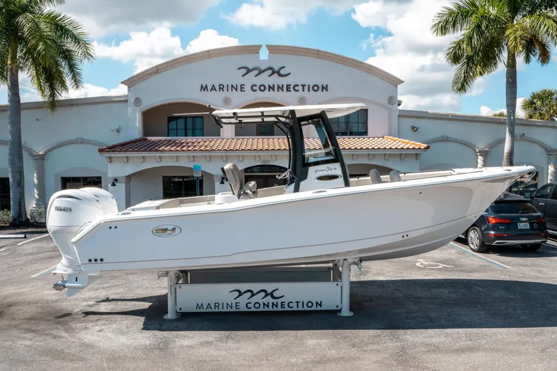 Slide: The Image of 2025 Sea Hunt Gamefish 25 boat displayed at Marine Connection dealership. - 1