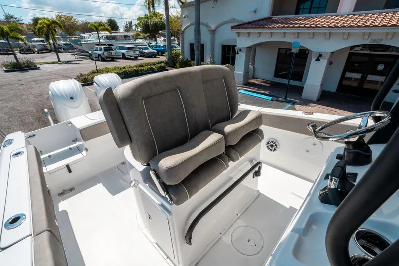 Slide: The Image of 2025 Sea Hunt Gamefish 25 boat interior with dual seats and steering wheel. - 26