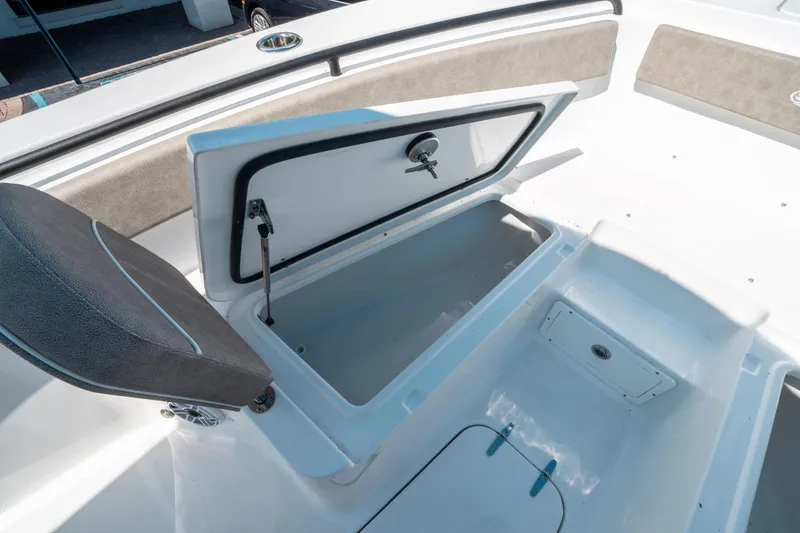 Slide: The Image of 2025 Sea Hunt Gamefish 25 boat storage compartment with open hatch and seating. - 36