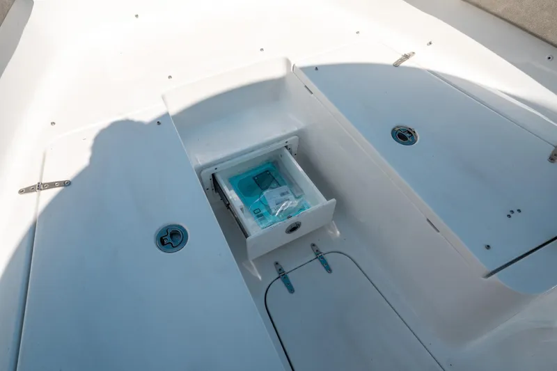 Slide: The Image of 2025 Sea Hunt Gamefish 25 boat deck with open storage compartment. - 38