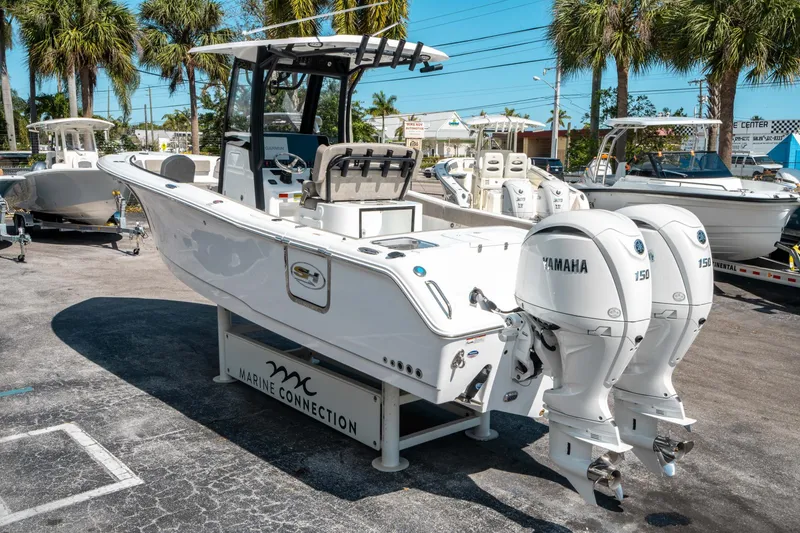 Slide: The Image of 2025 Sea Hunt Gamefish 25 boat with twin Yamaha 150 engines, displayed outdoors. - 4
