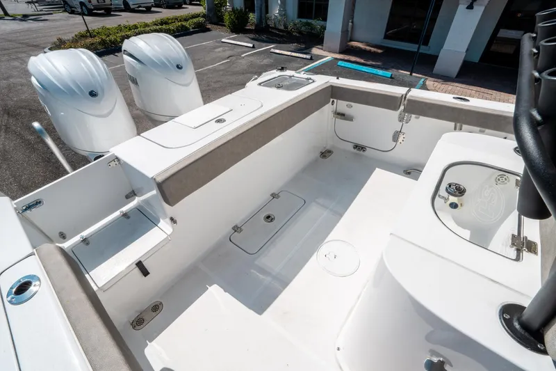 Slide: The Image of 2025 Sea Hunt Gamefish 25 boat interior with dual engines and spacious deck layout. - 12