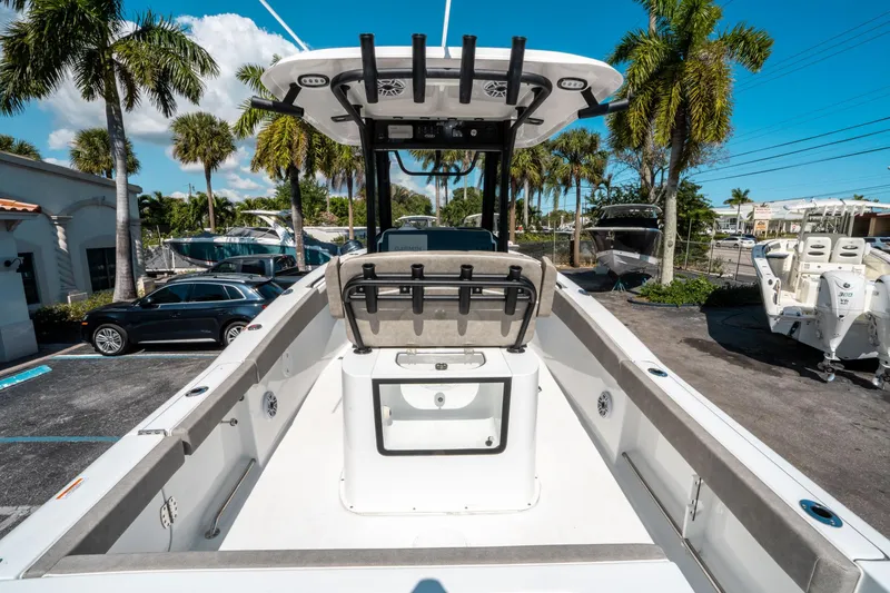 Slide: The Image of 2025 Sea Hunt Gamefish 25 boat, spacious deck, palm trees in background, sunny day. - 9