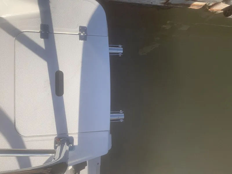 Slide: The Image of Rear view of a 2025 Hurricane SD 2050 boat docked by the water. - 11