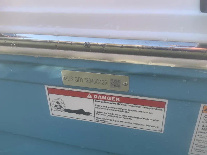 Slide: The Image of Hurricane SD 2050 boat with warning label and serial number plate, 2025 model. - 23