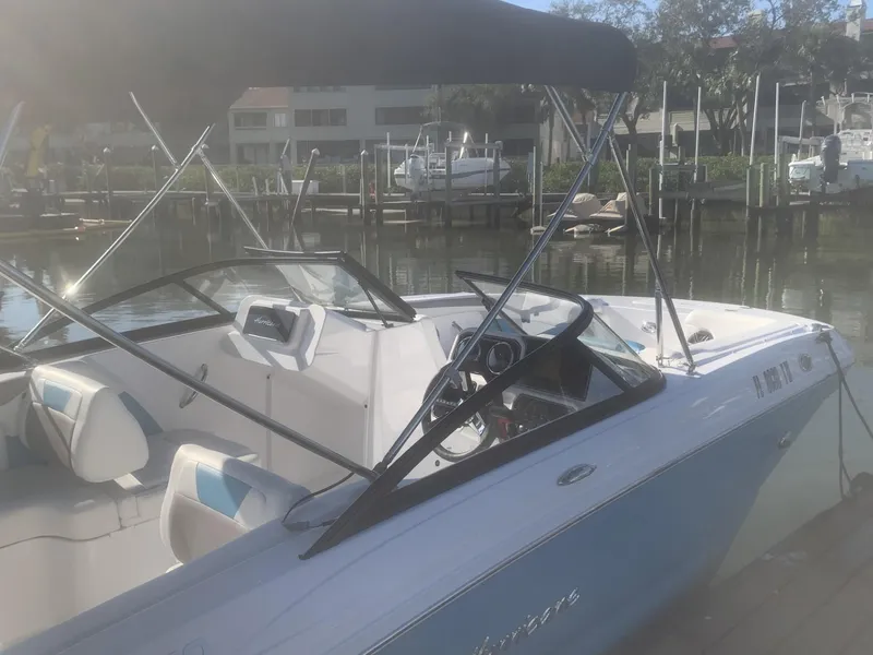 Slide: The Image of 2025 Hurricane SD 2050 boat docked in a marina, featuring a sleek design and spacious interior. - 4