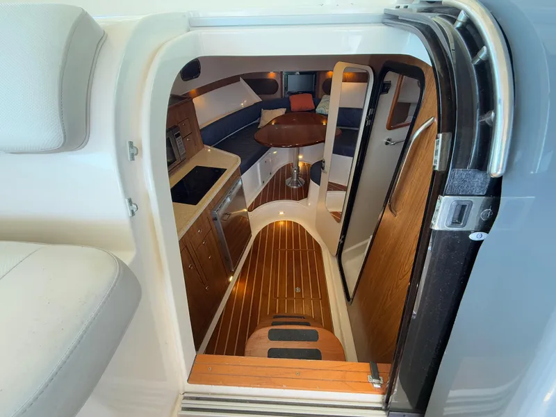 Slide: The Image of Ceiling-mounted fixture inside 2011 Pursuit OS 345 Offshore boat, featuring a metal handle and bolts. - 11