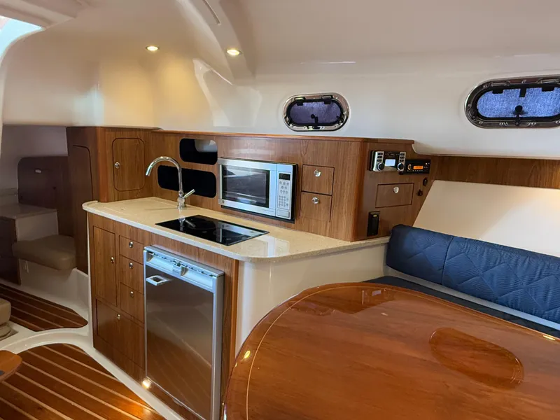 Slide: The Image of 2011 Pursuit OS 345 Offshore cabin interior with wood flooring and modern amenities. - 14
