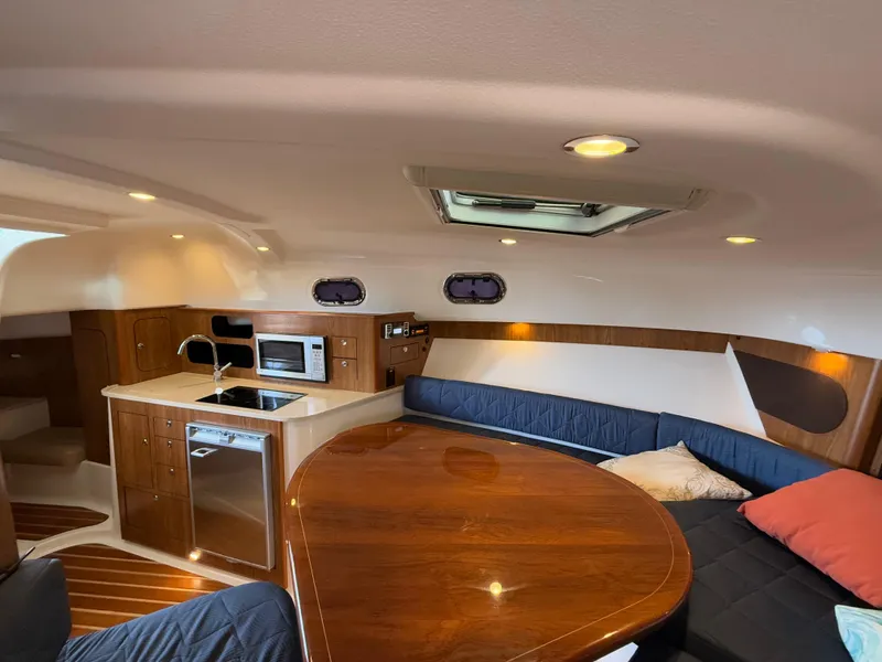Slide: The Image of Luxurious 2011 Pursuit OS 345 Offshore yacht interior with kitchenette and seating area. - 15