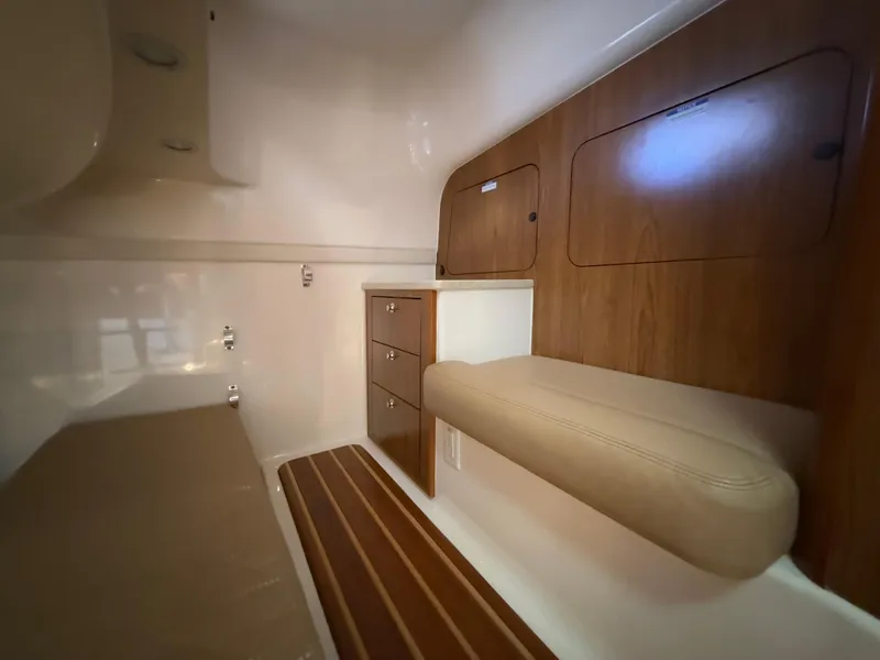 Slide: The Image of 2011 Pursuit OS 345 Offshore yacht interior with kitchen, microwave, and seating area. - 17