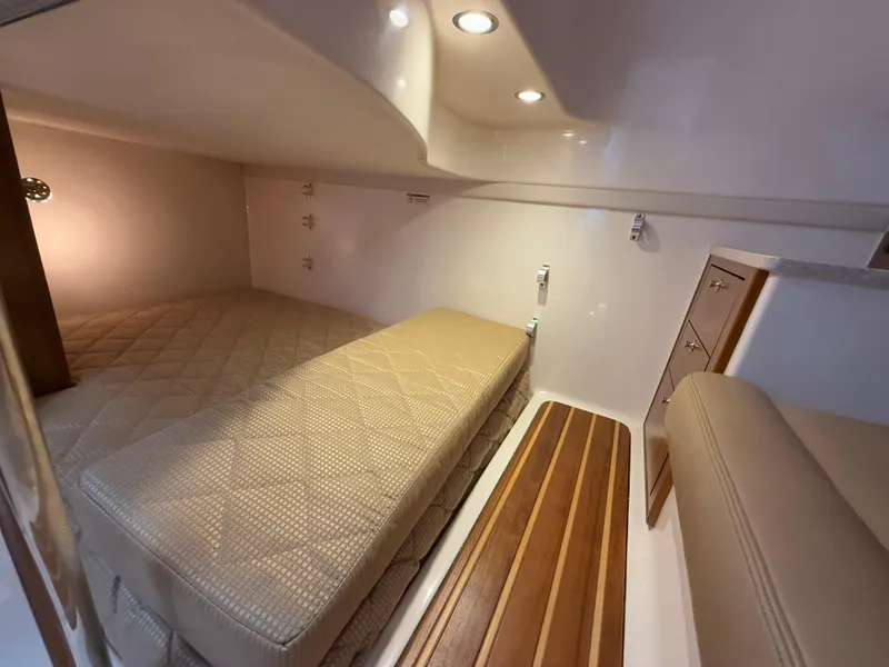 Slide: The Image of 2011 Pursuit OS 345 Offshore cabin interior with kitchenette and seating area. - 18