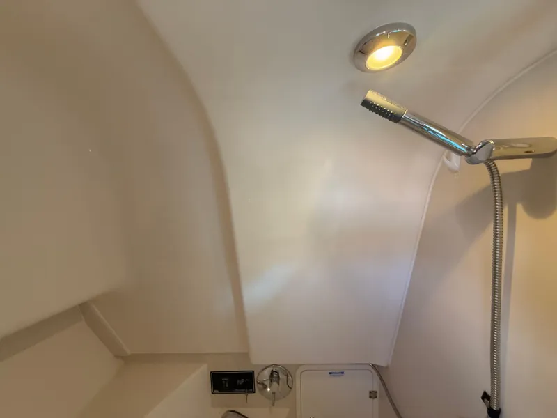 Slide: The Image of 2011 Pursuit OS 345 Offshore cabin interior with cozy bedding and wooden flooring. - 21