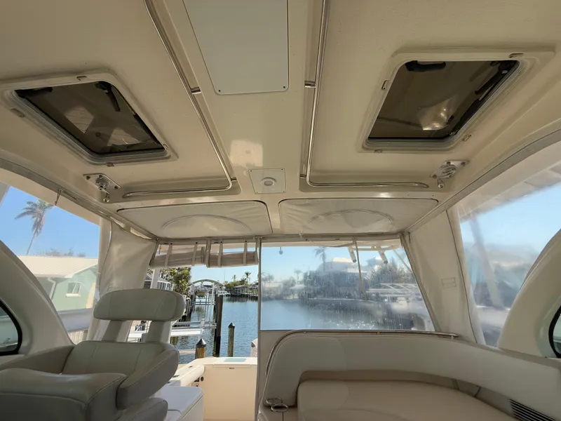 Slide: The Image of 2011 Pursuit OS 345 Offshore boat bathroom with glass sink and compact toilet. - 23