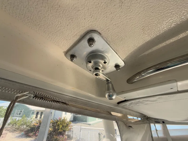 Slide: The Image of 2011 Pursuit OS 345 Offshore helm with steering wheel, navigation controls, and comfortable seating. - 8