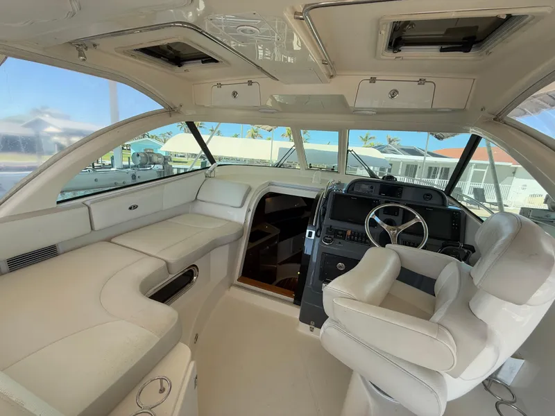 Slide: The Image of 2011 Pursuit OS 345 Offshore boat dashboard with navigation screens and steering wheel. - 9