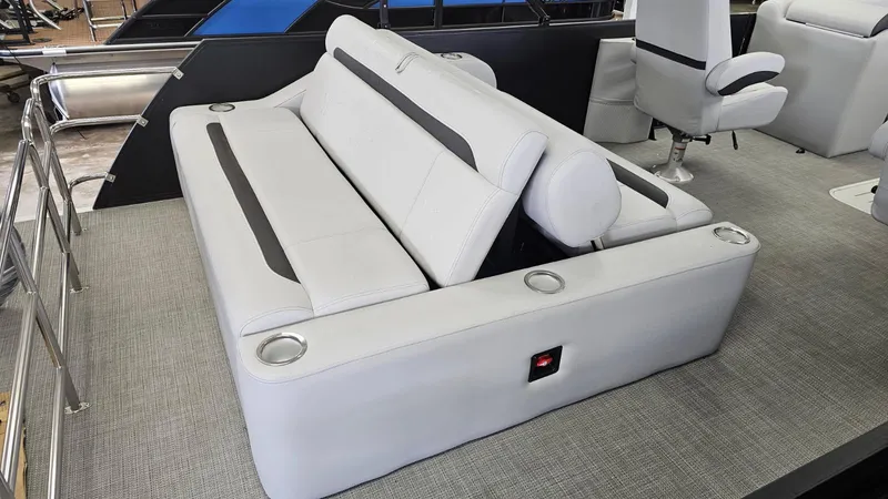 Slide: The Image of 2025 Bentley Pontoons Legacy 223 Swingback interior with luxurious seating and cup holders. - 14