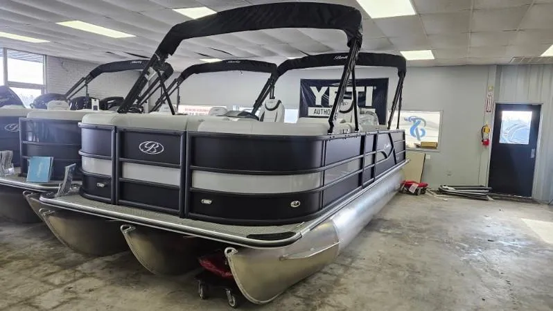 Slide: The Image of 2025 Bentley Pontoons Legacy 223 Swingback in showroom, featuring sleek design and modern amenities. - 2