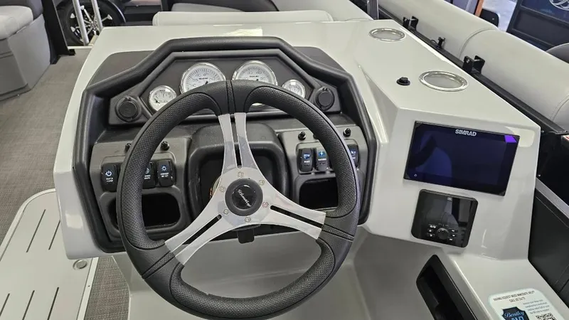 Slide: The Image of 2025 Bentley Pontoons Legacy 223 Swingback dashboard with steering wheel and control panel. - 5