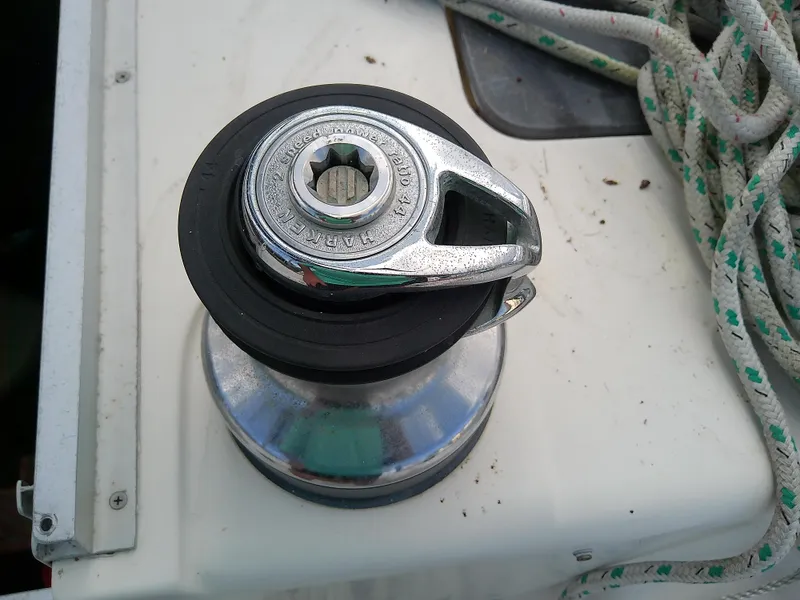 Slide: The Image of Winch on 1990 Hunter Passage 42 sailboat deck with coiled rope. - 23