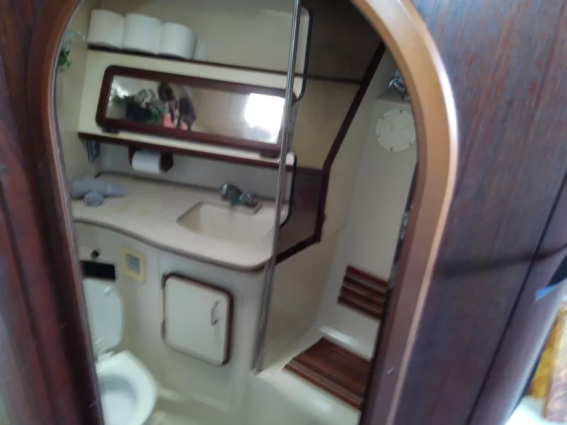 Slide: The Image of Bathroom interior of 1990 Hunter Passage 42 yacht, featuring sink, toilet, and wooden accents. - 30