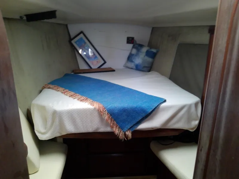 Slide: The Image of Cozy cabin interior of 1990 Hunter Passage 42 sailboat with bed and blue blanket. - 32