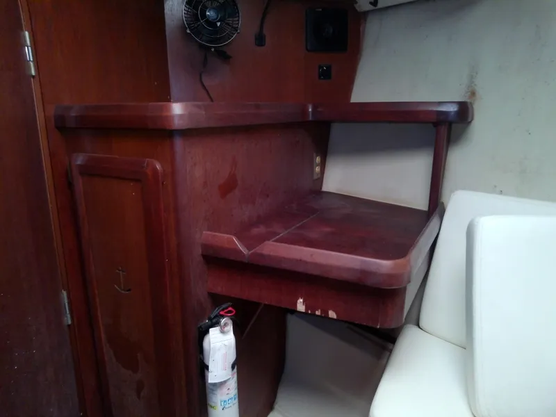 Slide: The Image of 1990 Hunter Passage 42 interior with wooden desk and fire extinguisher. - 33